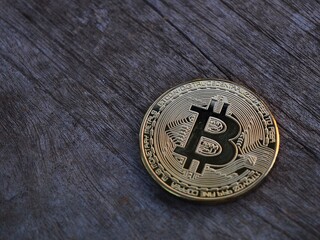 Close-up of physical bitcoin or litecoin on wooden. Virtual Cryptocurrency concept