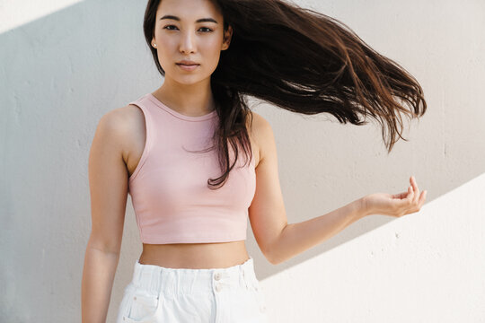 Image of young asian beautiful girl showing her hair