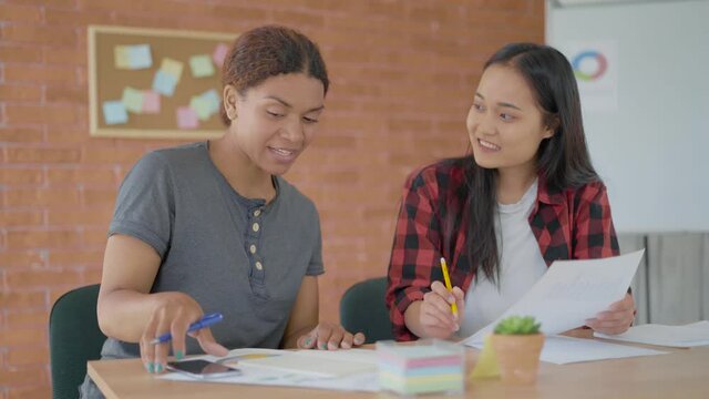 group of 2 people. charming student girls doing school assignment in class. 4K