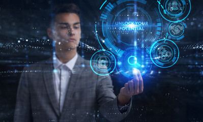 Business, Technology, Internet and network concept. Young businessman working on a virtual screen of the future and sees the inscription: Unlock your potential