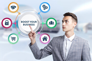 Business, Technology, Internet and network concept. Young businessman working on a virtual screen of the future and sees the inscription: Boost your business