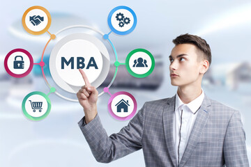 Business, Technology, Internet and network concept. Young businessman working on a virtual screen of the future and sees the inscription: MBA