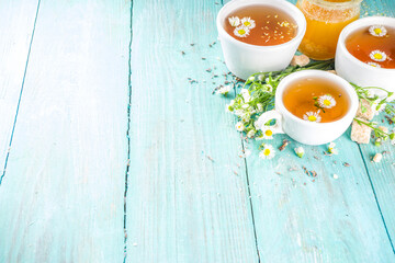 Chamomile and honey natural organic tea, on a blue wooden table
