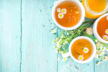Chamomile and honey natural organic tea, on a blue wooden table