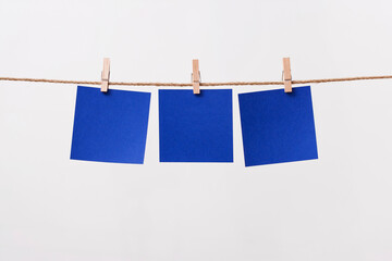 paper cards hanging rope isolated on white background
