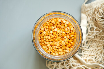 Close-up peas flat lay. Organic bio products in zero waste shop. Foods storage kitchen low waste lifestyle. Cereals and grains in glass jars. Eco friendly shopping plastic free grocery store.