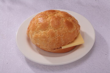 Close up of a typical Cantonese and Hong Kong bread Pineapple Bun with butter