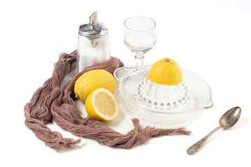 Lemon and lemon squeezer in glass