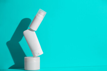 Set of blank white skincare cosmetic products on background with free space for advertising text.