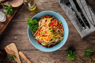 Funchoza noodle salad with stripes of vegetables