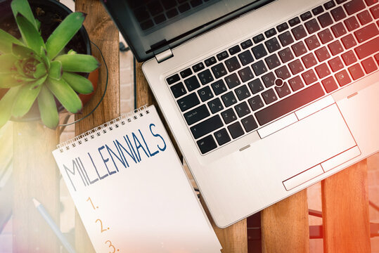 Handwriting text Millennials. Conceptual photo an individual reaching young adulthood in the early 21st century Personal workplace overview with laptop device used for individual interest