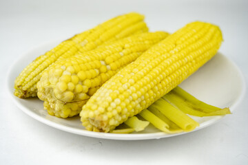 boiled sweet corn on a white plate