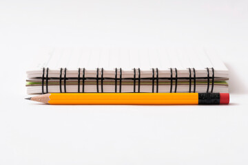 pencil and notebook on white background
