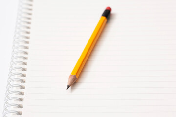 pencil and notebook on white background
