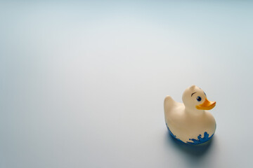 Rubber duck on light blue background 