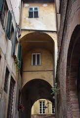 Fototapeta na wymiar The atmospheric narrow street with the buildings in Tuscany Italy
