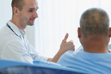 Doctor encourage his patient in the hospital by report a good health check result.