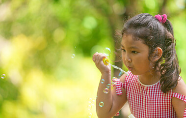 beautiful Kids blowing bubble outdoor happy lifestyle