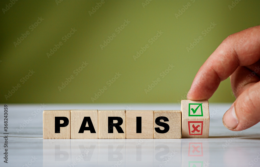 Poster the hand turns the wooden cube and changes the word paris with red tick check box and red reject x c