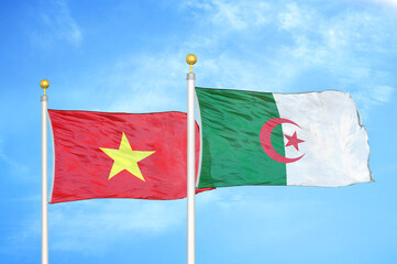 Vietnam and Algeria  two flags on flagpoles and blue sky