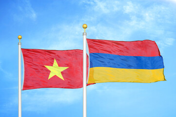 Vietnam and Armenia  two flags on flagpoles and blue sky