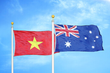Vietnam and Australia  two flags on flagpoles and blue sky