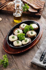 Baked stuffed champignon hats in a pan 