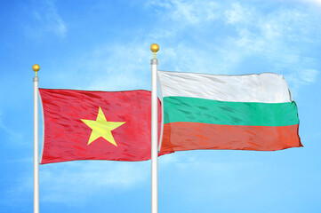 Vietnam and Bulgaria  two flags on flagpoles and blue sky