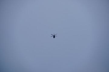 Hubschrauber Transport am grauen Himmel