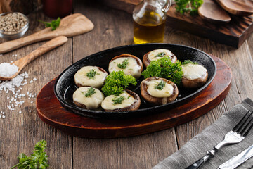 Baked stuffed champignon hats in a pan 