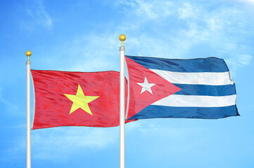 Vietnam and Cuba two flags on flagpoles and blue sky