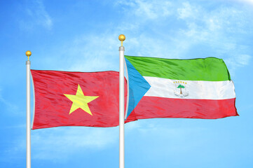 Vietnam and Equatorial Guinea two flags on flagpoles and blue sky
