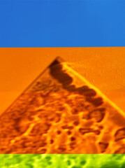 Abstract landscape with pyramide on colorful background. Art photo. Symbol from Egyptian pyramid with sand texture and water drops