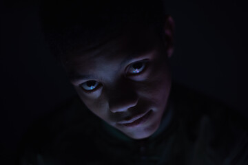Close up portrait of teenager in dark room