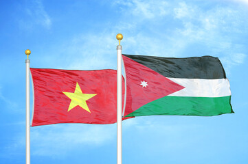 Vietnam and Jordan two flags on flagpoles and blue sky