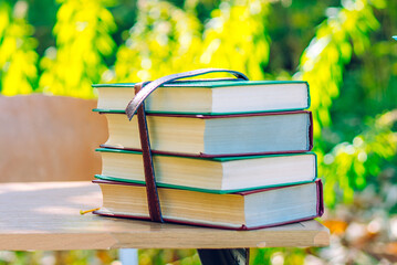 stack of books on the grass