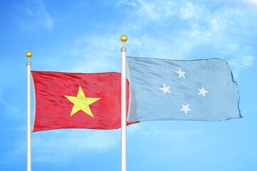 Vietnam and Micronesia two flags on flagpoles and blue sky