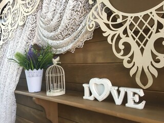 Photozone "Love" with a bird outside the cage and a vase of flowers