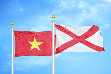 Vietnam and Northern Ireland two flags on flagpoles and blue sky