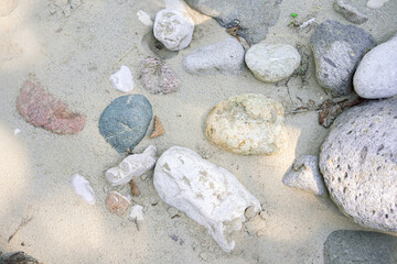 Fototapeta na wymiar Various stones in the sand