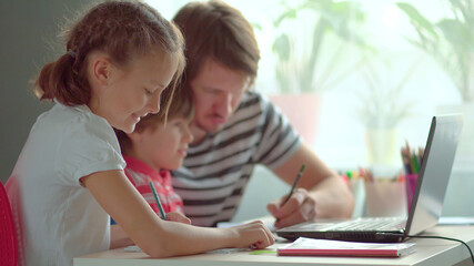Cute children use laptop for education, online study, home studying, Boy and Girl have homework at...