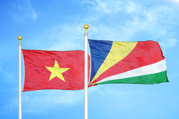 Vietnam and Seychelles two flags on flagpoles and blue sky
