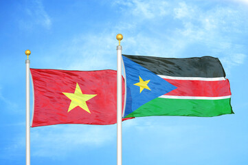 Vietnam and South Sudan two flags on flagpoles and blue sky