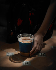 Fototapeta na wymiar Woman holding iced coffee.