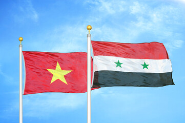 Vietnam and Syria two flags on flagpoles and blue sky