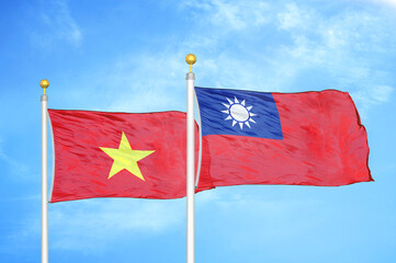 Vietnam and Taiwan two flags on flagpoles and blue sky