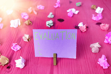 Writing note showing Evaluation. Business concept for the making of judgment about the amount or...