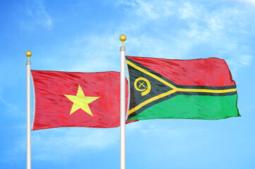 Vietnam and Vanuatu two flags on flagpoles and blue sky
