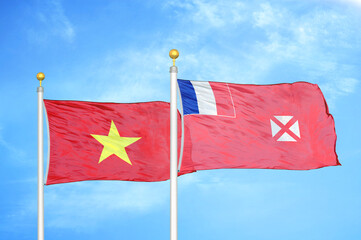 Vietnam and Wallis and Futuna two flags on flagpoles and blue sky