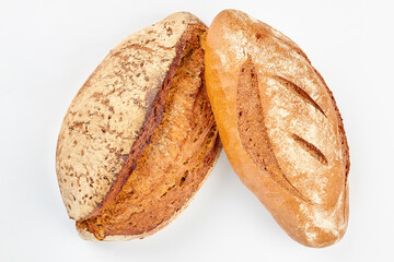 Artisan bread on white background. Two loaves on wheat bread on white background.